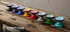 Cheatcode YoYos group photo, all colors in a line, July 2023