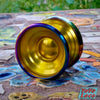 Motion Perpetual bi-metal YoYo, Shining Citrus colorway, set on a mosaic tile park bench