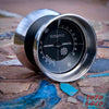 yoyofriends Tankette Bi-metal yoyo, Midnight Gray with raw rims, early morning photo  on a mosaic tile bench