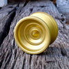 One Drop Thorn YoYo, Gold, on old railroad tie